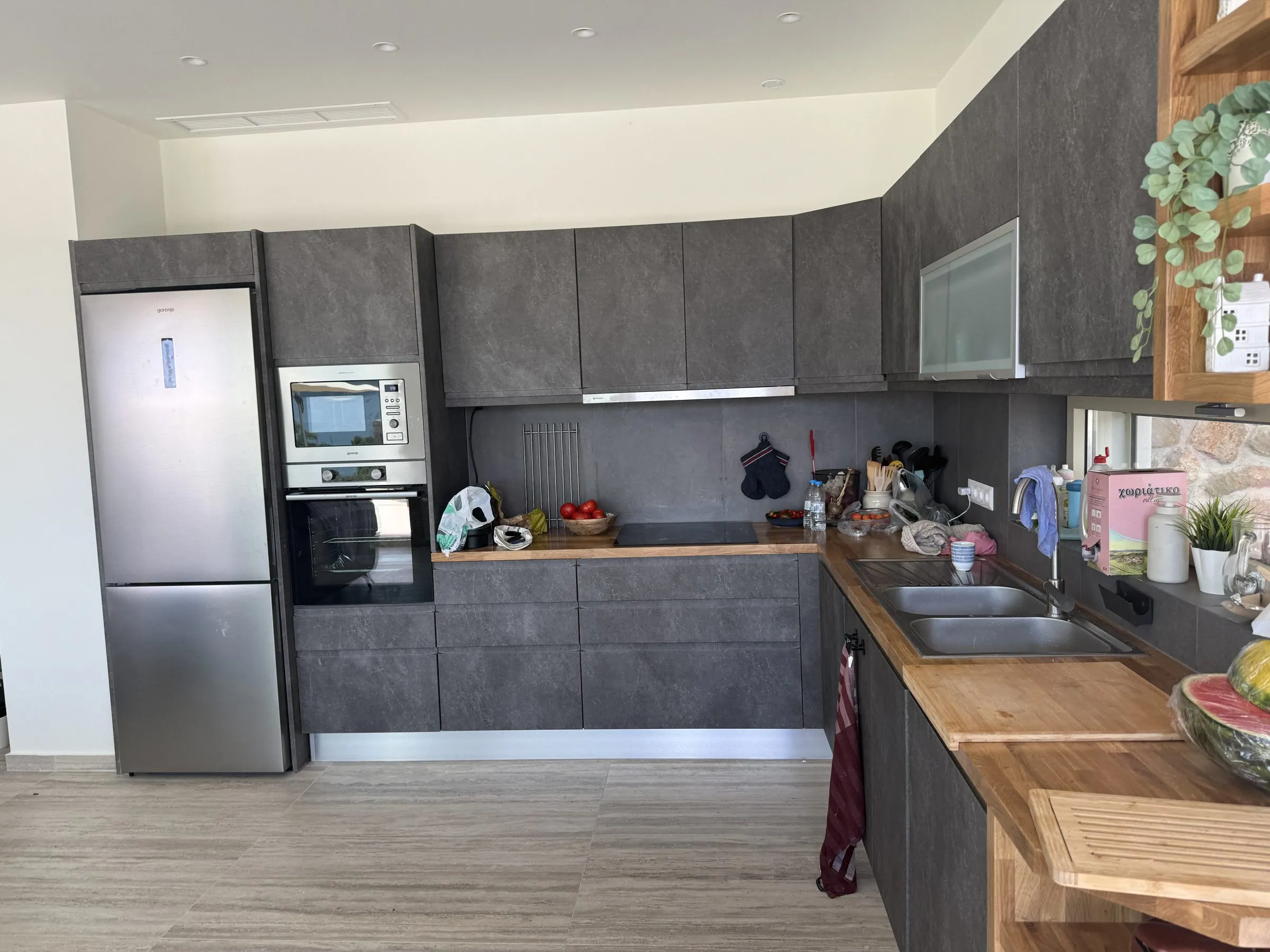 Contemporary kitchen at Villa Prima with anthracite cabinetry, solid-wood worktops, oven and a large fridge-freezer.
